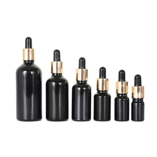 5 ml 10 ml 15 ml 20 ml 30 ml 50 ml 60 ml 100 ml Verschiedene Volumina Schwarze Glasflasche mit ätherischen Ölen und goldener Aluminium-Tropfflasche für die Hautpflege