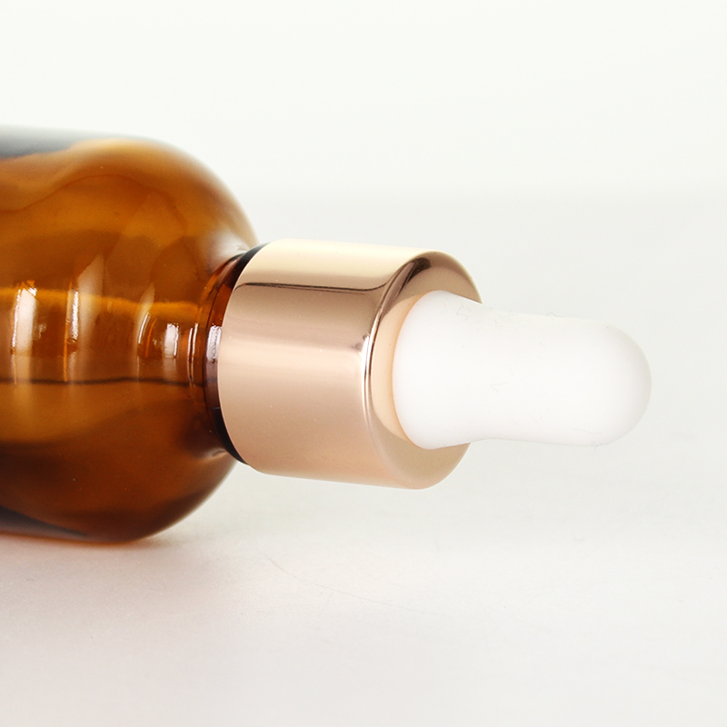 Bernsteinfarbene Hautpflege-Serumflasche aus Glas mit goldenem Aluminium-Tropfer für ätherisches Öl